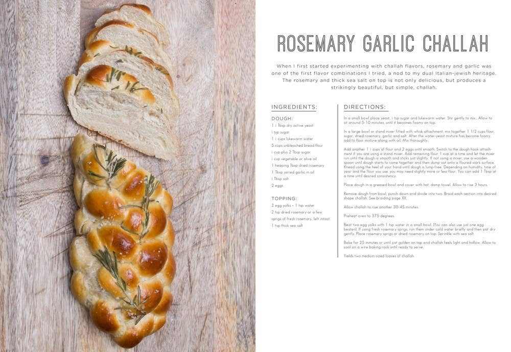Hardcover Modern Jewish Baker cookbook with rosemary garlic challah recipe and sliced challah loaf on wooden background