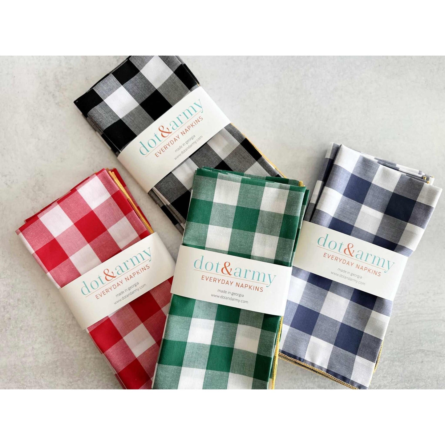 Set of four colorful gingham check cloth napkins with honey mustard edging, lightweight and easy care cotton blend.