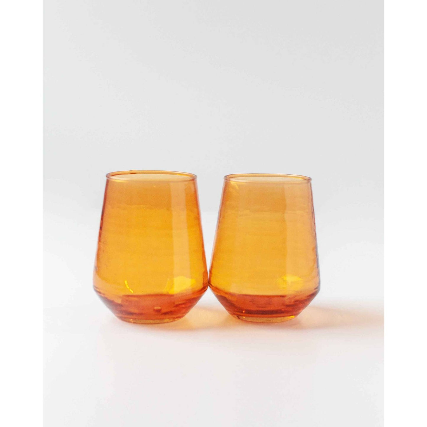 
                  
                    A pair of amber handblown hammered glass water tumblers. - Curated Home Decor
                  
                
