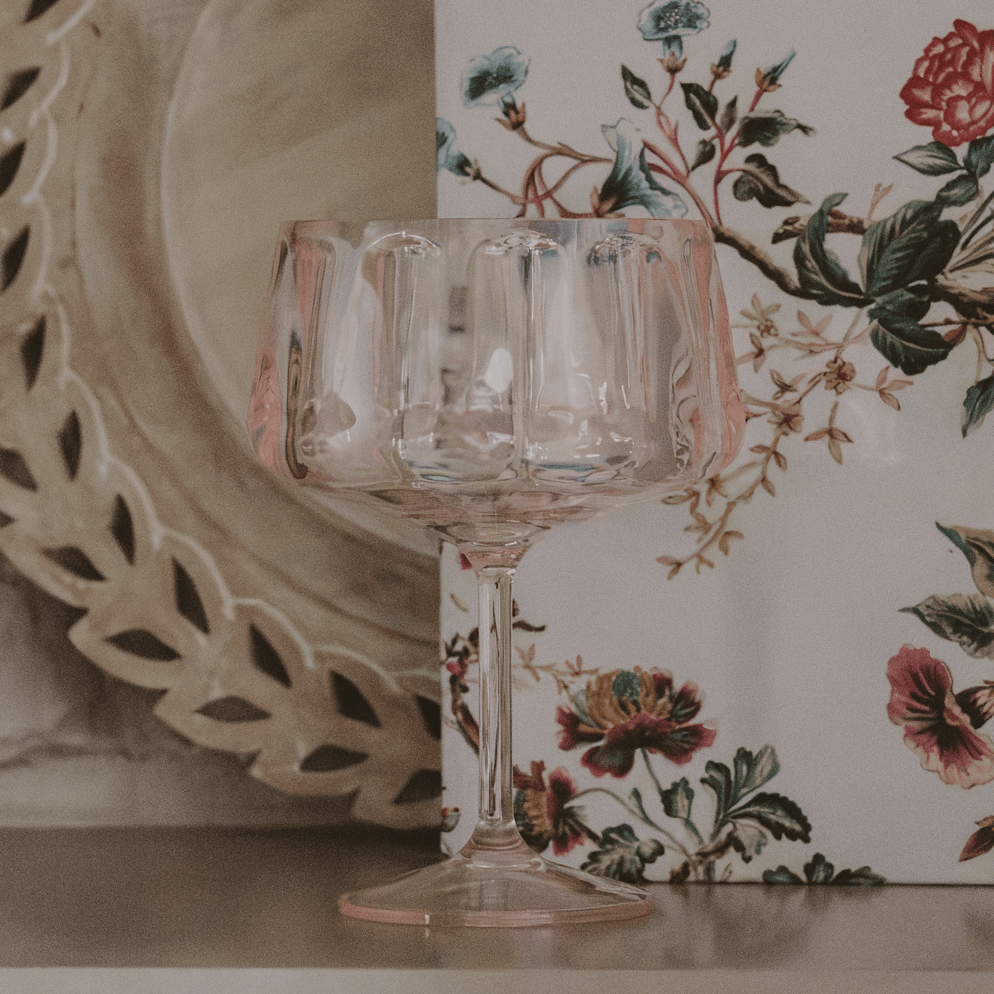 Pink tinted outdoor plastic coupe glass for cocktails and mocktails, 15oz, BPA-free and reusable.