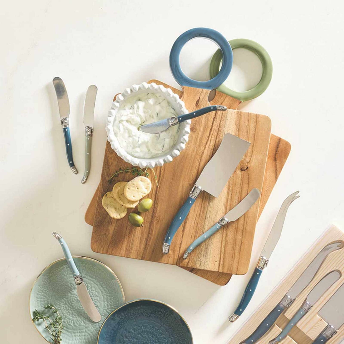 Set of three blue charcuterie knives with stainless steel blades for slicing and spreading cheese