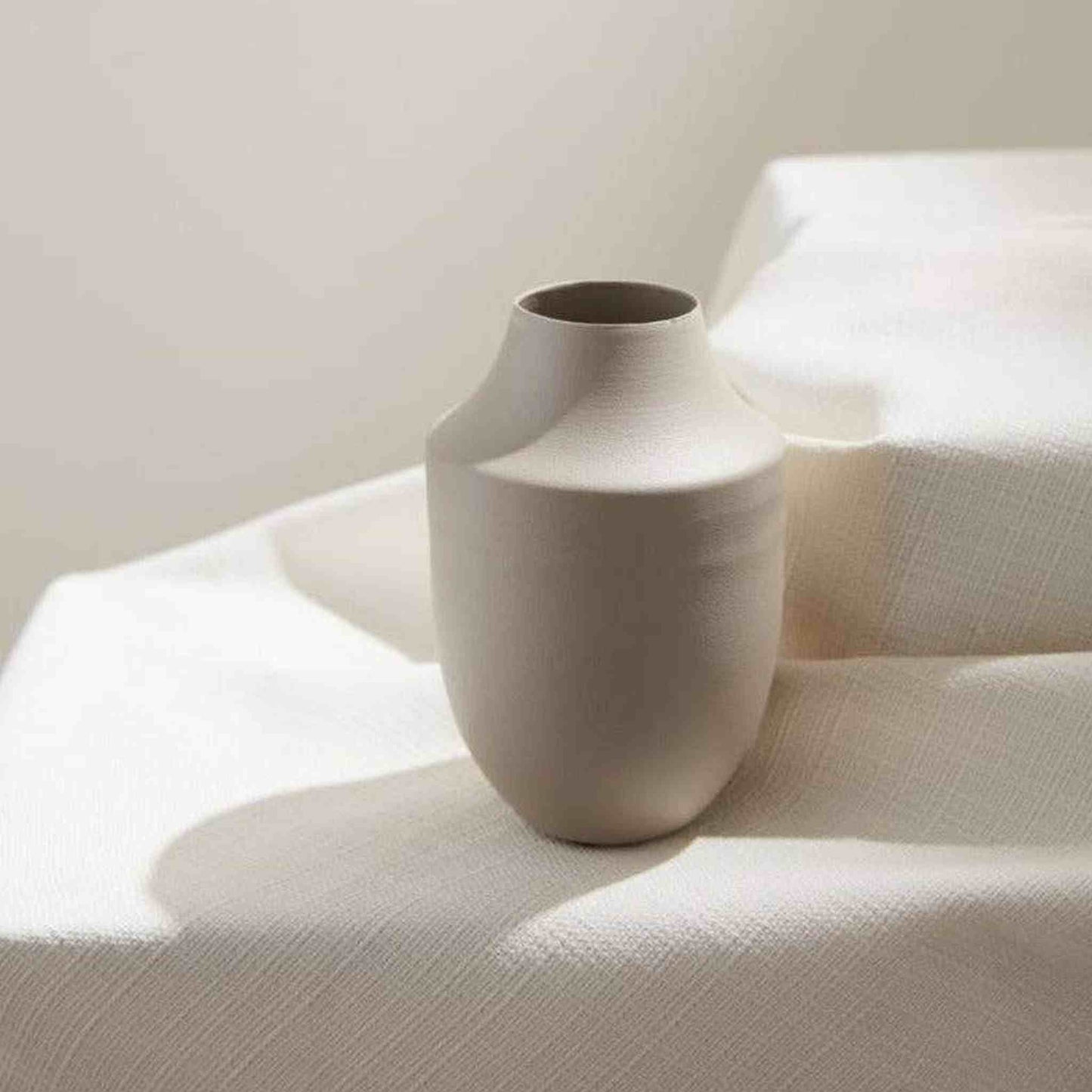 Petite cherry blossom branches in pink paired with a sleek metal Milan vase