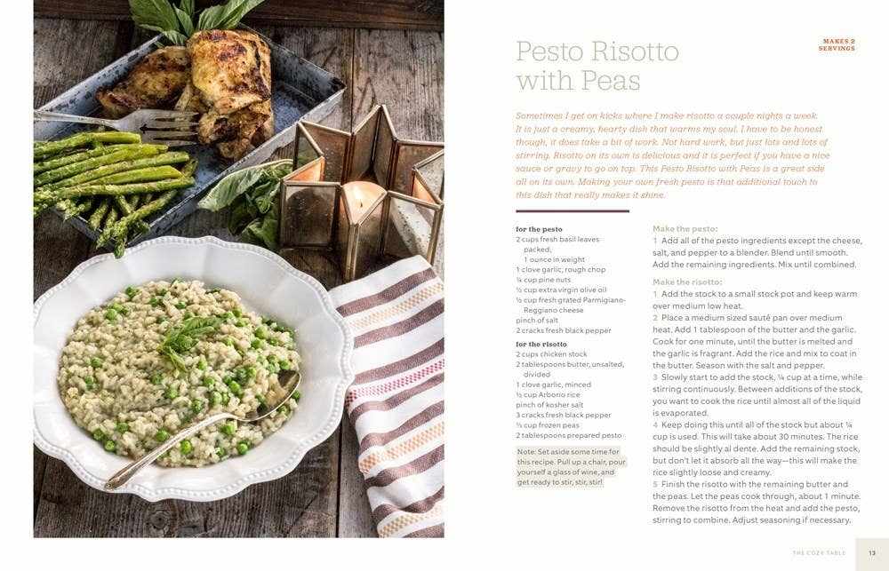The Cozy Table cookbook with pesto risotto and roasted chicken on wooden table