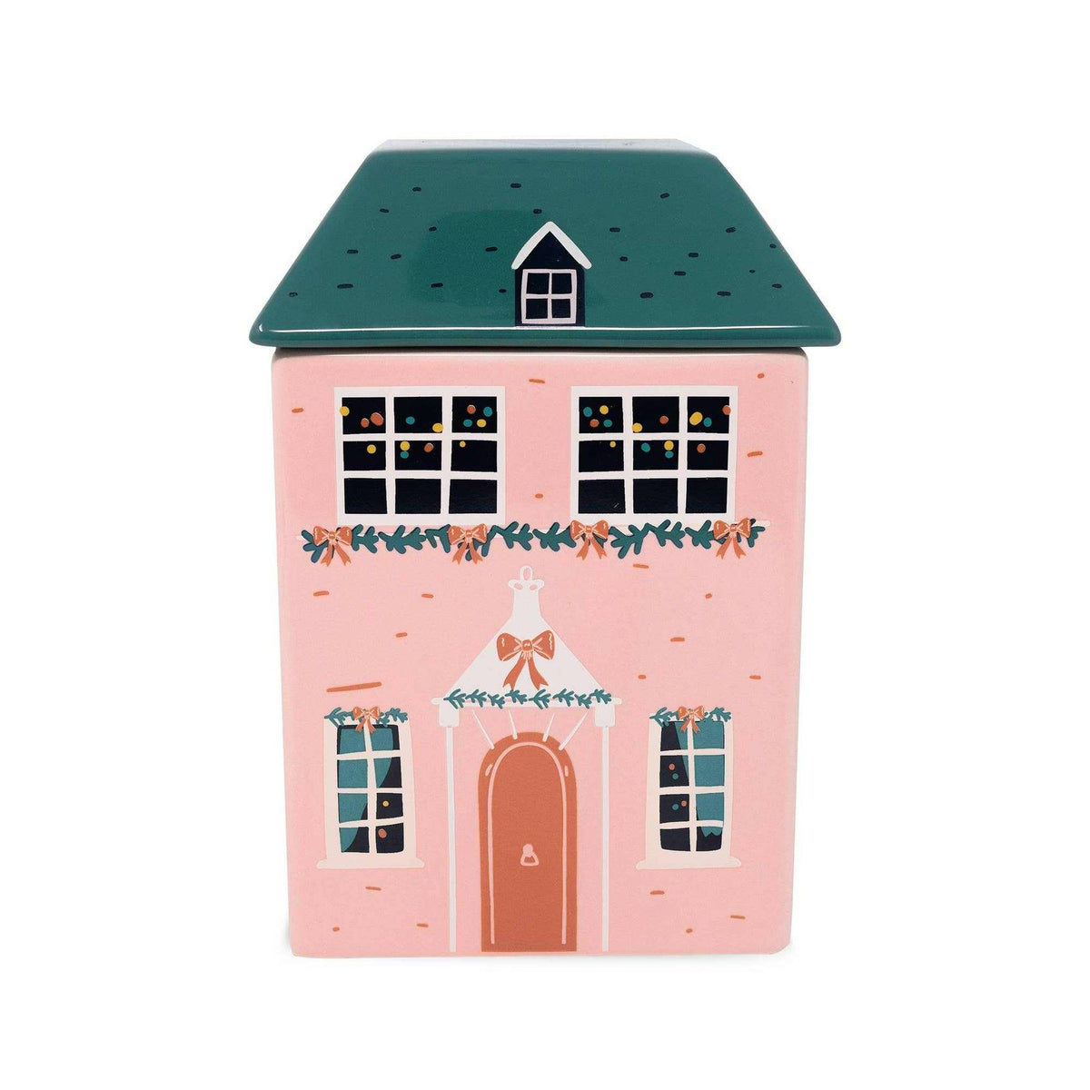 
                  
                    Ceramic cookie jar shaped like a festive holiday cottage with a green roof and pink walls decorated for Christmas
                  
                