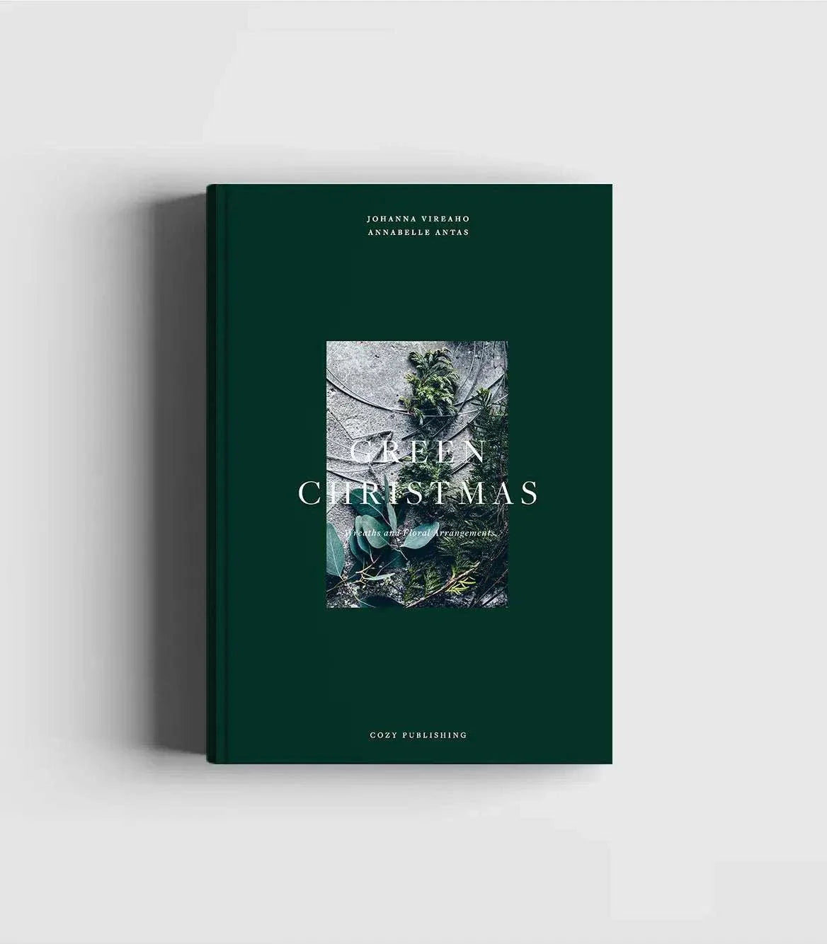 Green Christmas book with festive floral wreath cover and holiday greenery design