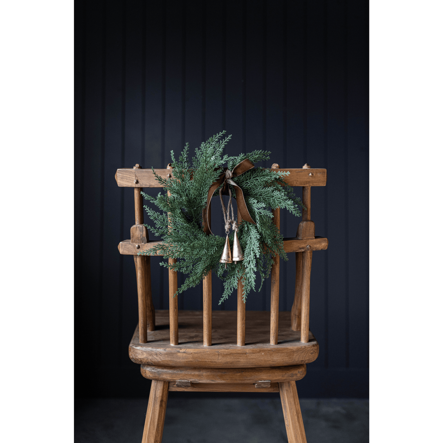 14-inch Cypress Leaf Full Real Touch Wreath with natural evergreen faux foliage on wooden chair