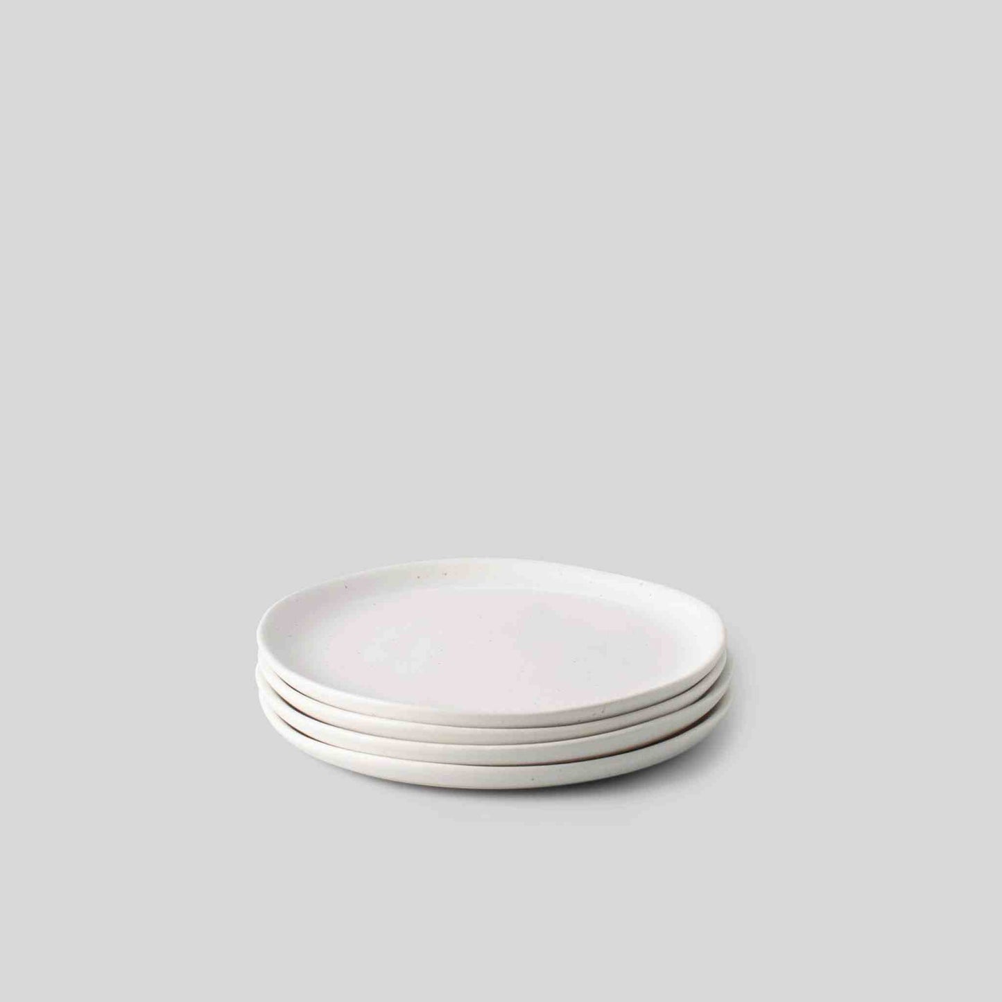 Set of 4 speckled white dessert plates, hand-finished stoneware with organic shapes, 6.5-inch diameter.