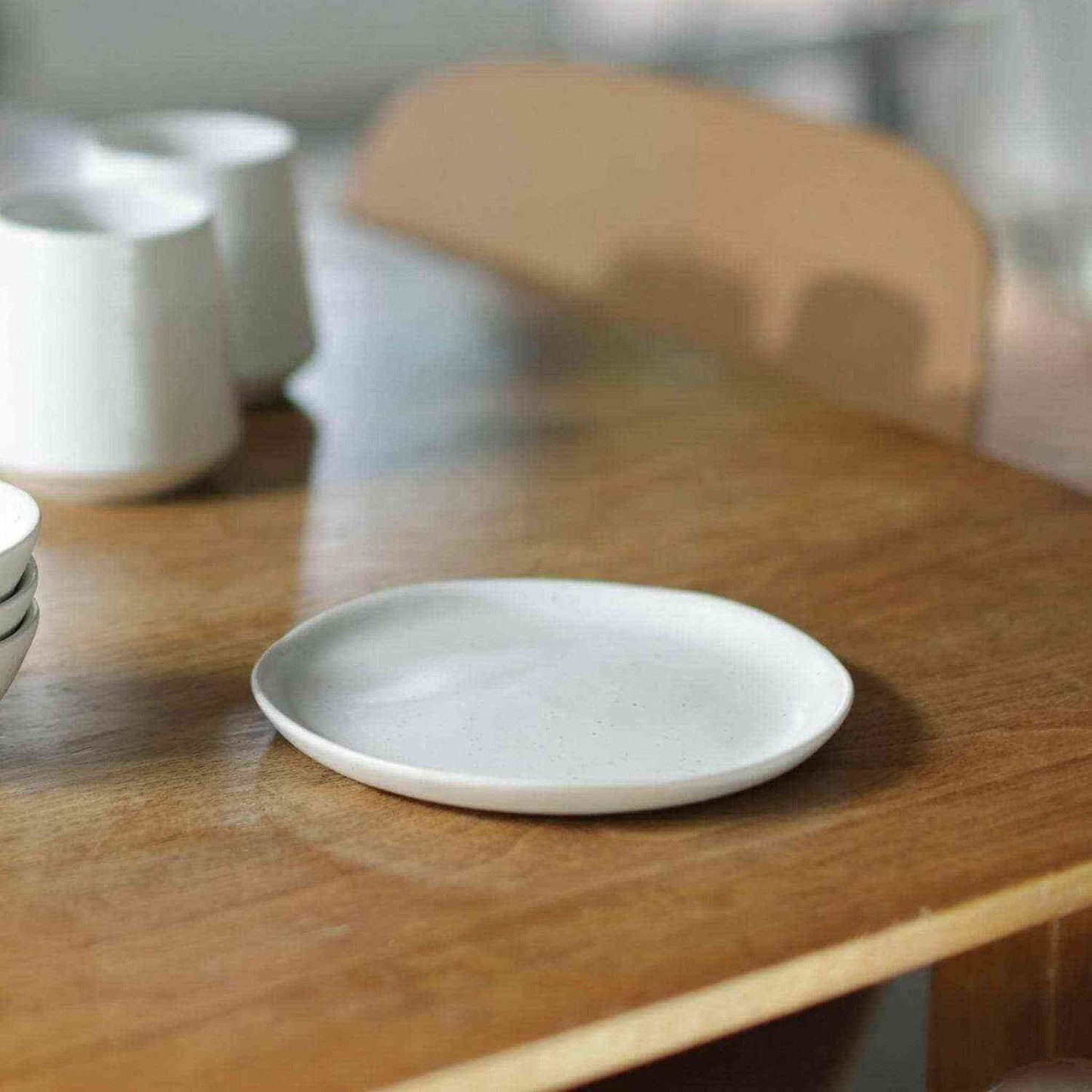 Set of 4 speckled white dessert plates made of artisan stoneware with organic shapes, handmade in Portugal.