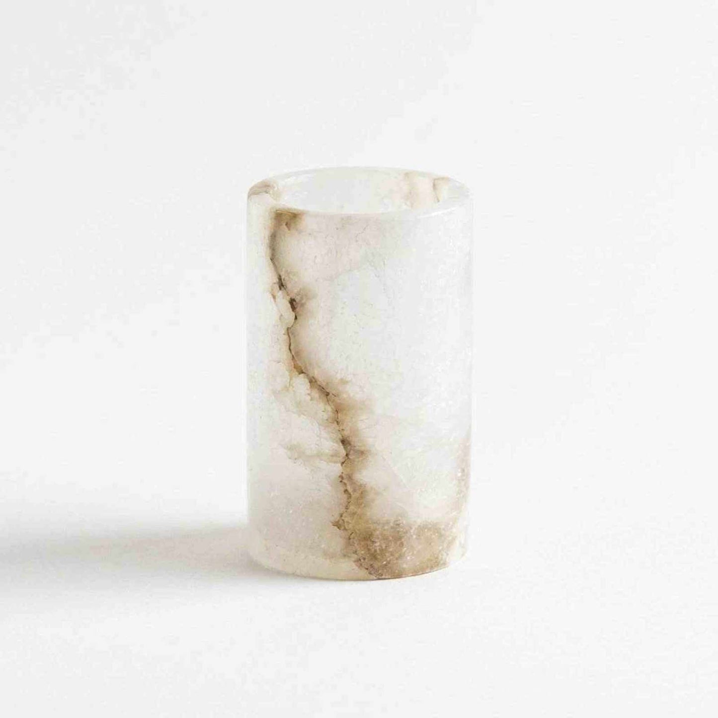 Hand-cut alabaster tealight holder glowing with warm light