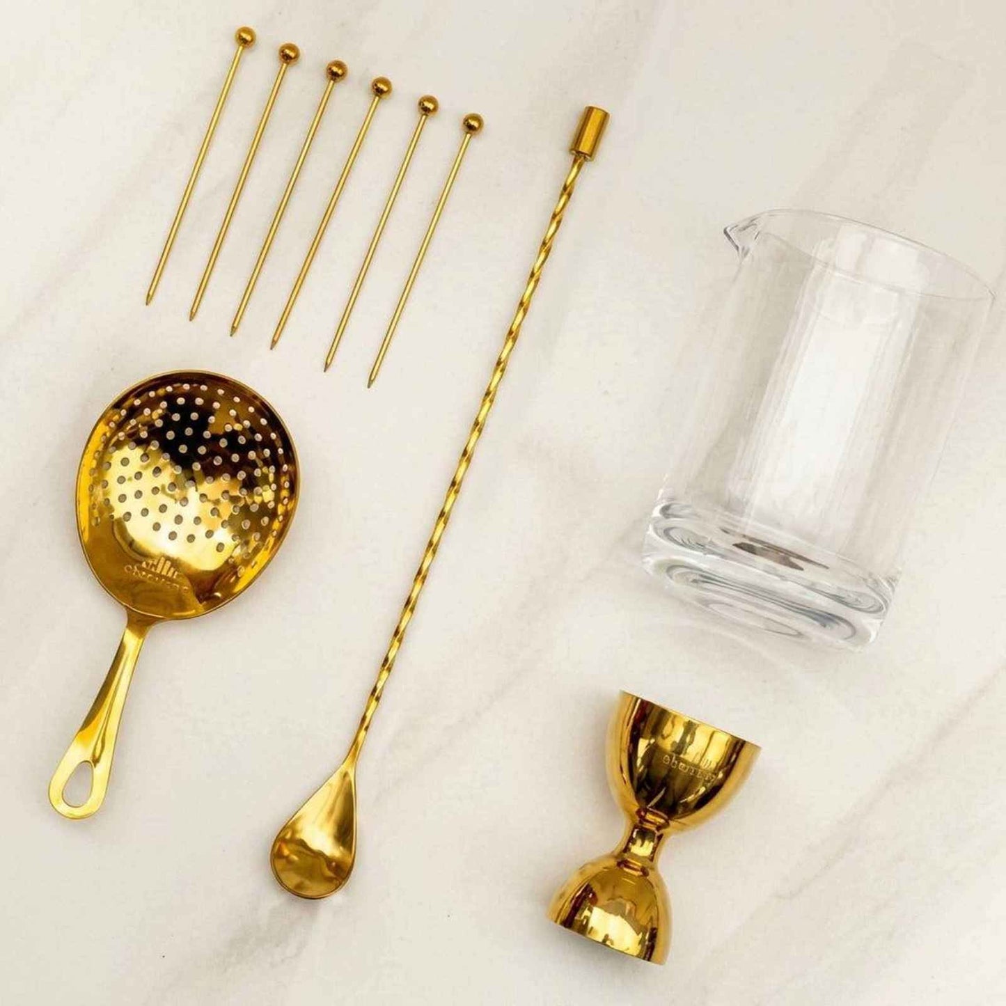 Gold gift box set with 10-piece cocktail barware including mixing glass, strainer, bar spoon, jigger, and picks