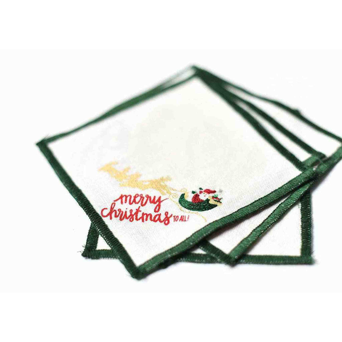 
                  
                    Set of 4 Flying Santa Cocktail Napkins with green border and festive Christmas design, 5x5 inches each
                  
                