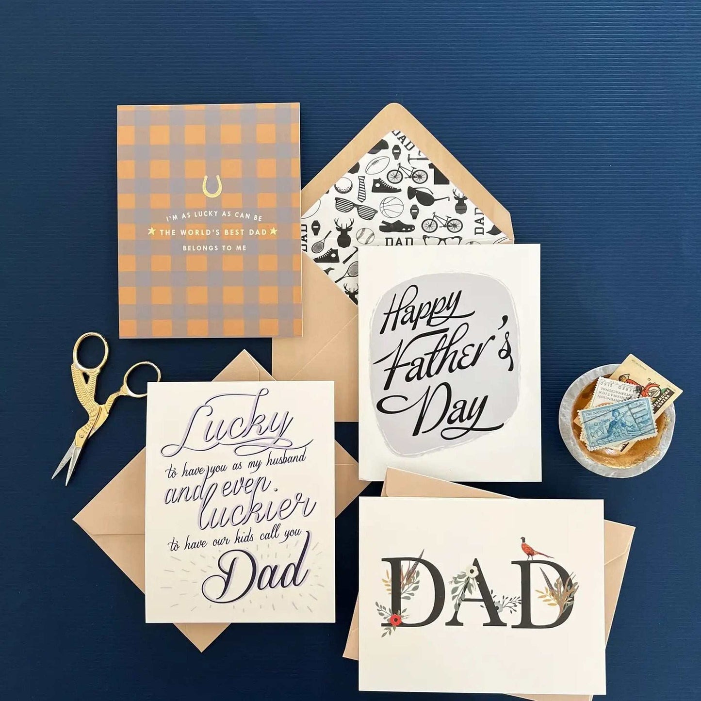 Best Dad Ever Card with gold foil, folded greeting card, blank interior, and stylish envelopes displayed on blue background