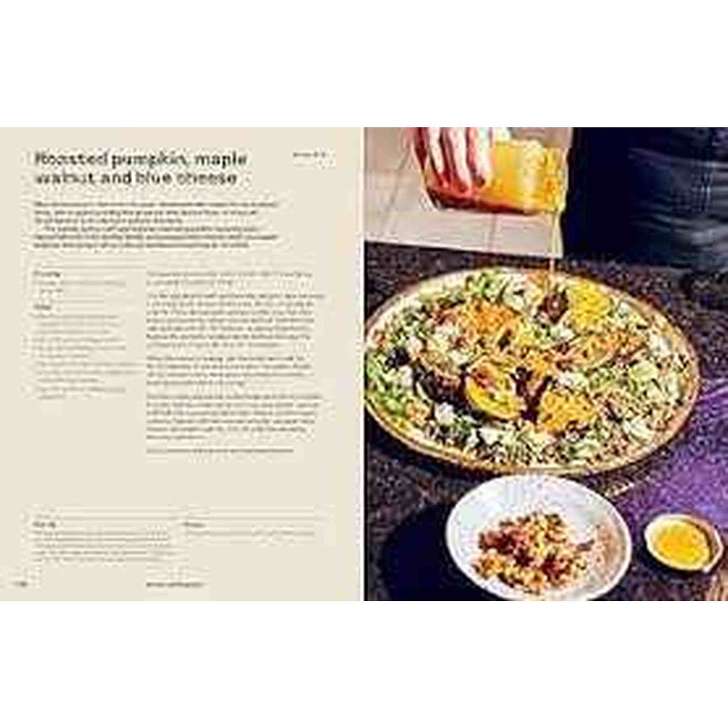 Open cookbook page of Epic Salads featuring roasted pumpkin salad recipe with dressing being poured over salad bowl