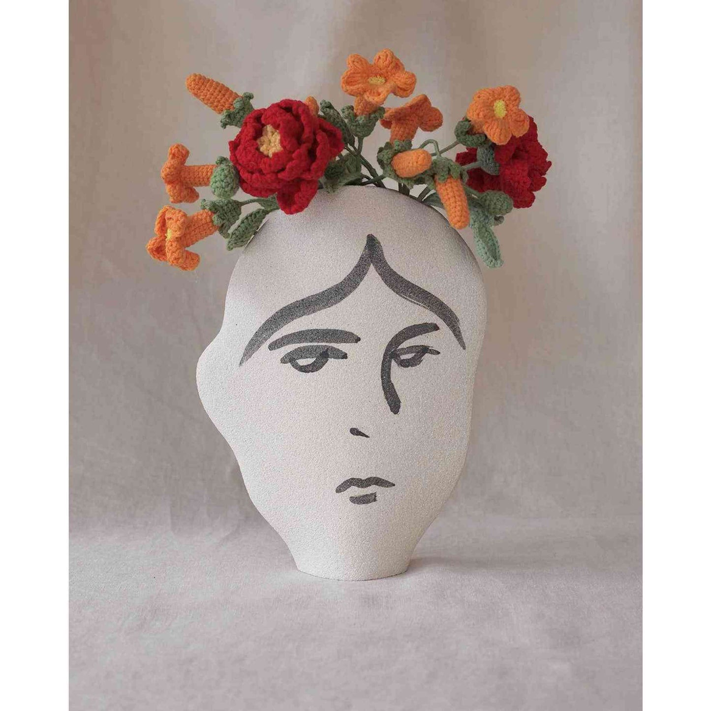 
                  
                    Handmade ceramic summer vase Frida N°2 with painted face design and crochet flowers
                  
                