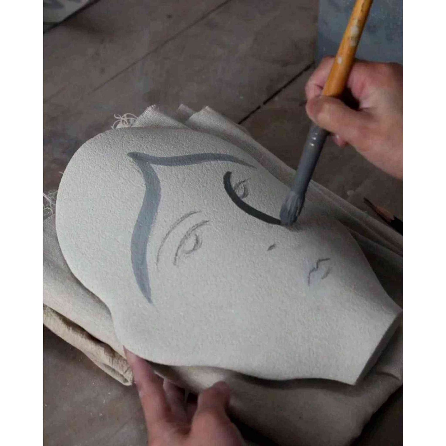 
                  
                    Hand-painted ceramic summer vase with figurative face motifs in progress
                  
                