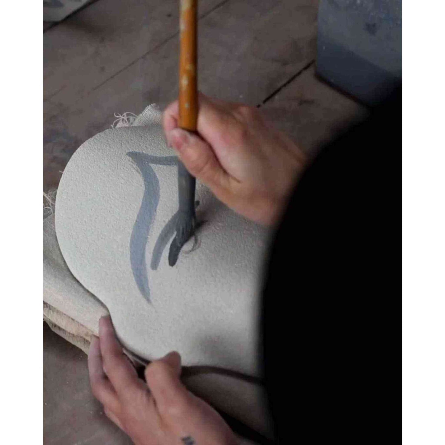 
                  
                    Hand-painted ceramic summer vase with figurative motifs being crafted by hand
                  
                