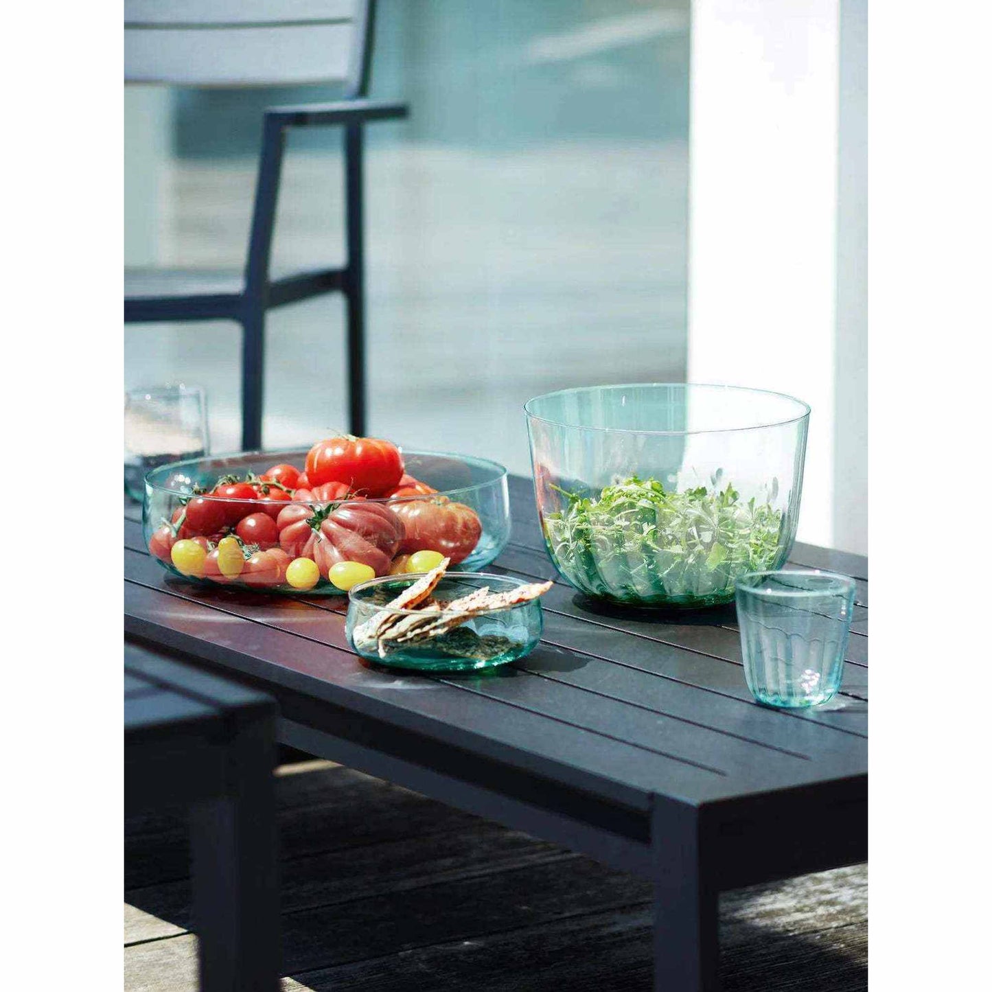 6in Mia Low Bowl made of recycled glass with fluted texture and low sides on outdoor table with snacks