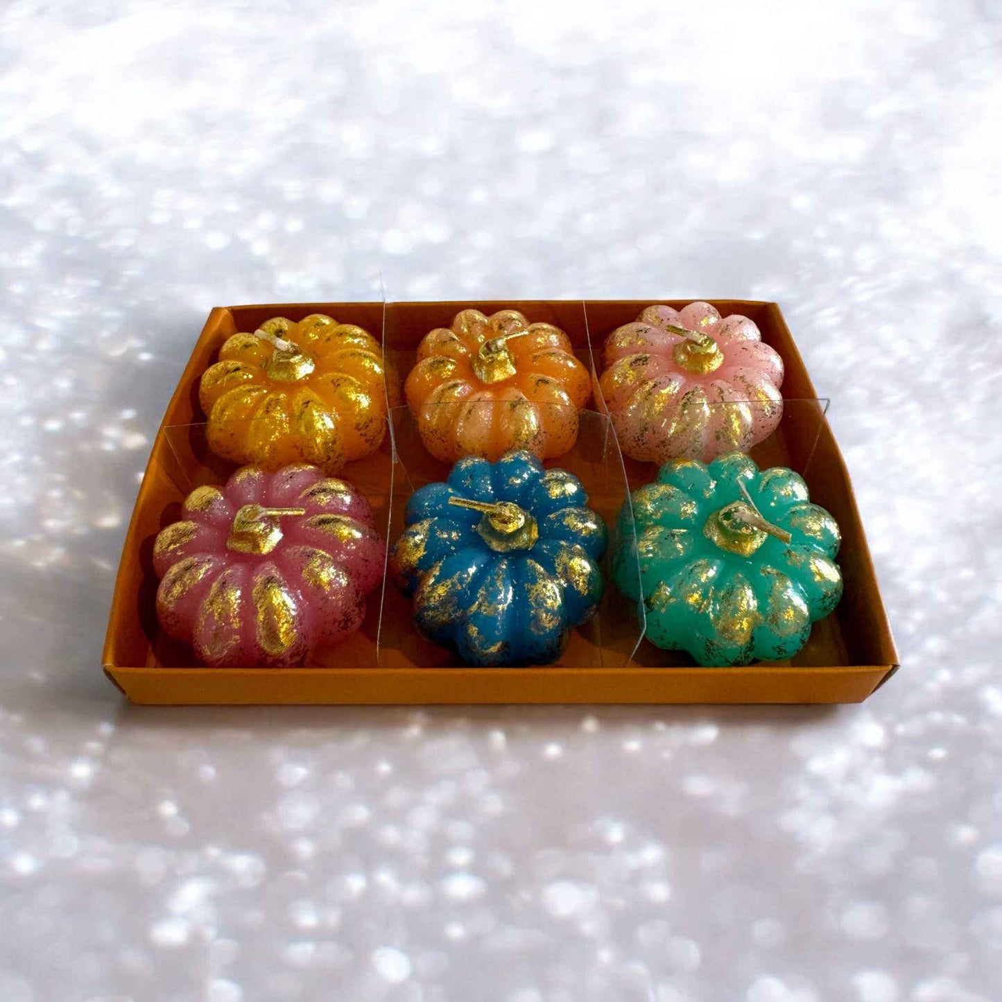 Set of 6 rainbow pumpkin tea lights with gold gild accents in a box