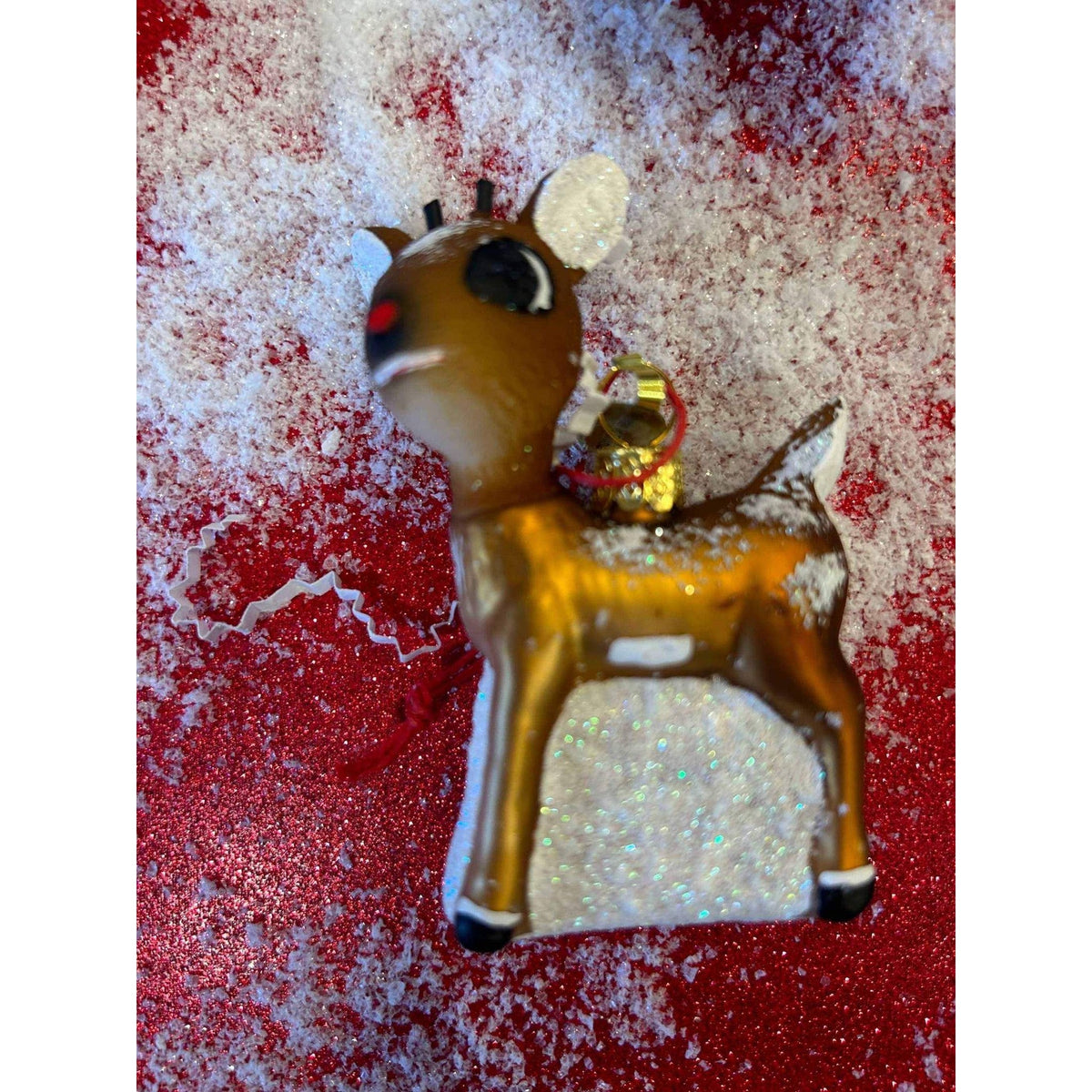 
                  
                    Retro Rudolph ornament with vintage-style detailing and matte-glitter finish on snowy red background
                  
                