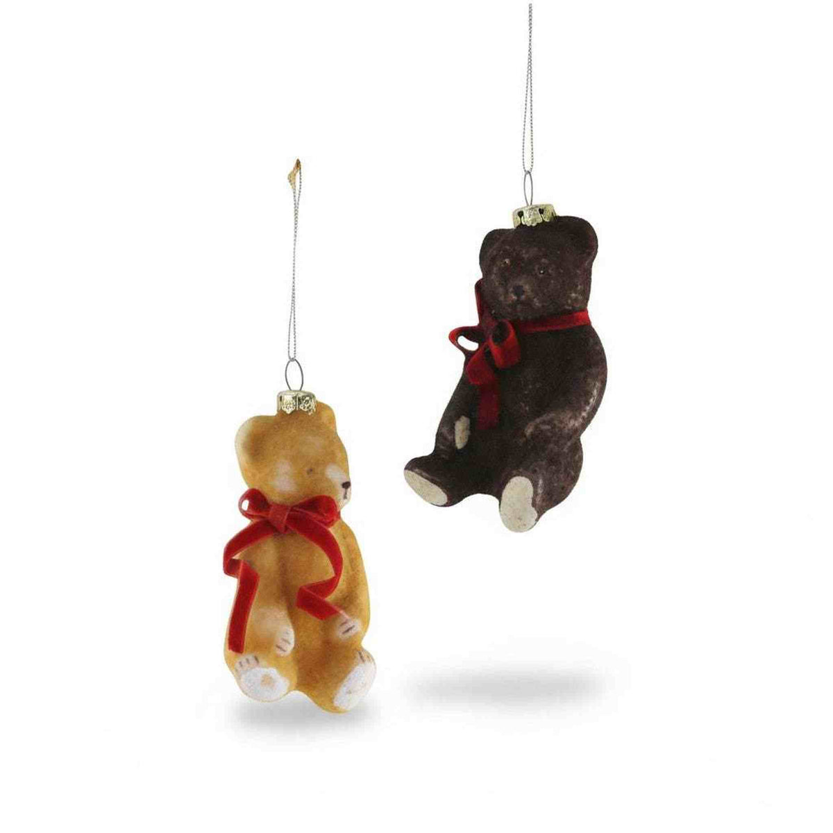 
                  
                    Two hand-crafted blown glass Teddy Bear Ornaments in soft brown tones with red bows hanging on strings for Christmas tree decoration
                  
                