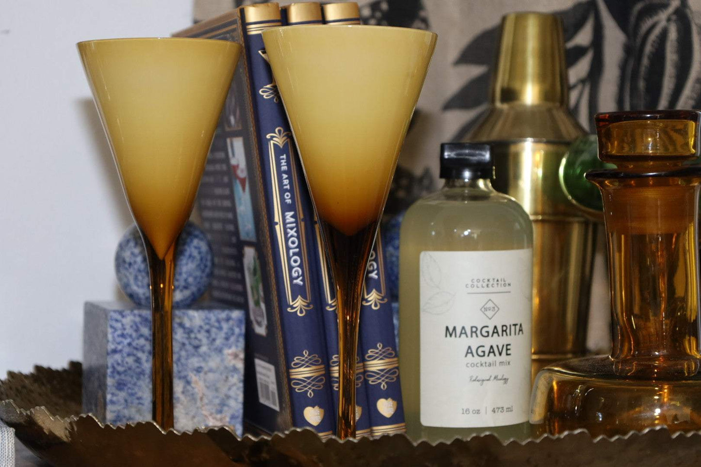 Margarita Agave Mixer bottle with two cocktail glasses and bar tools on a table
