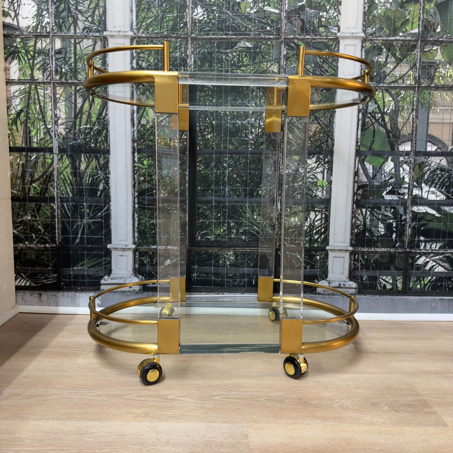 
                  
                    Full front view of vintage brass and Lucite rolling bar cart
                  
                