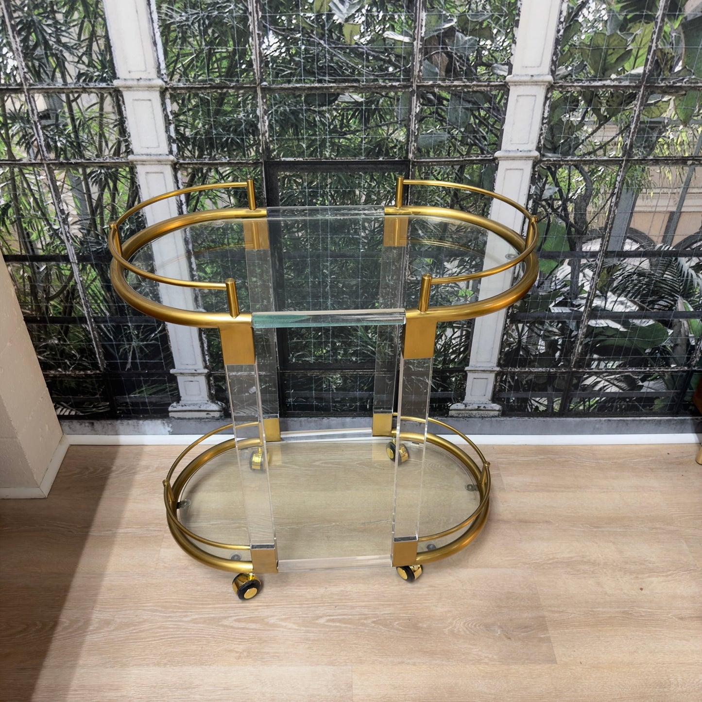 
                  
                    Top view showing oval glass shelves and brass rails
                  
                