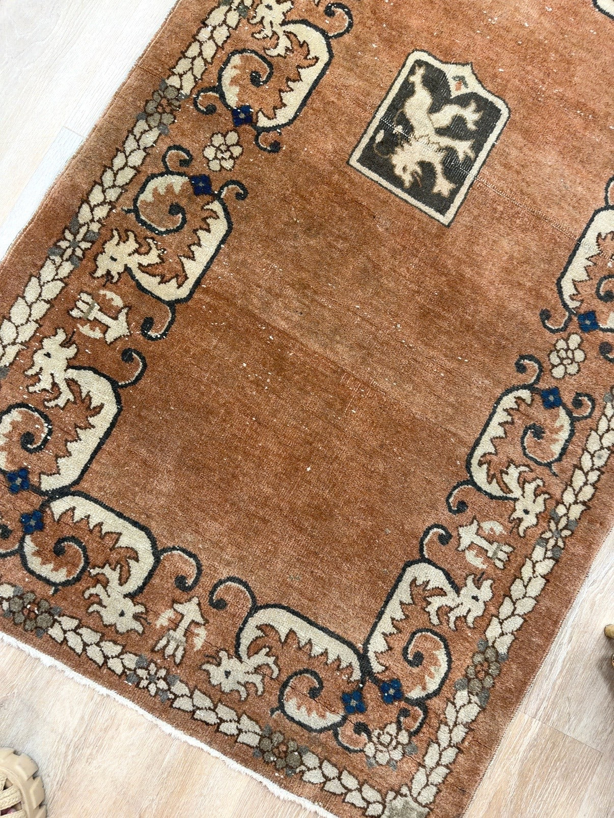 
                  
                    Angled condition view showing authentic pile variation and wear on vintage Turkish rug
                  
                